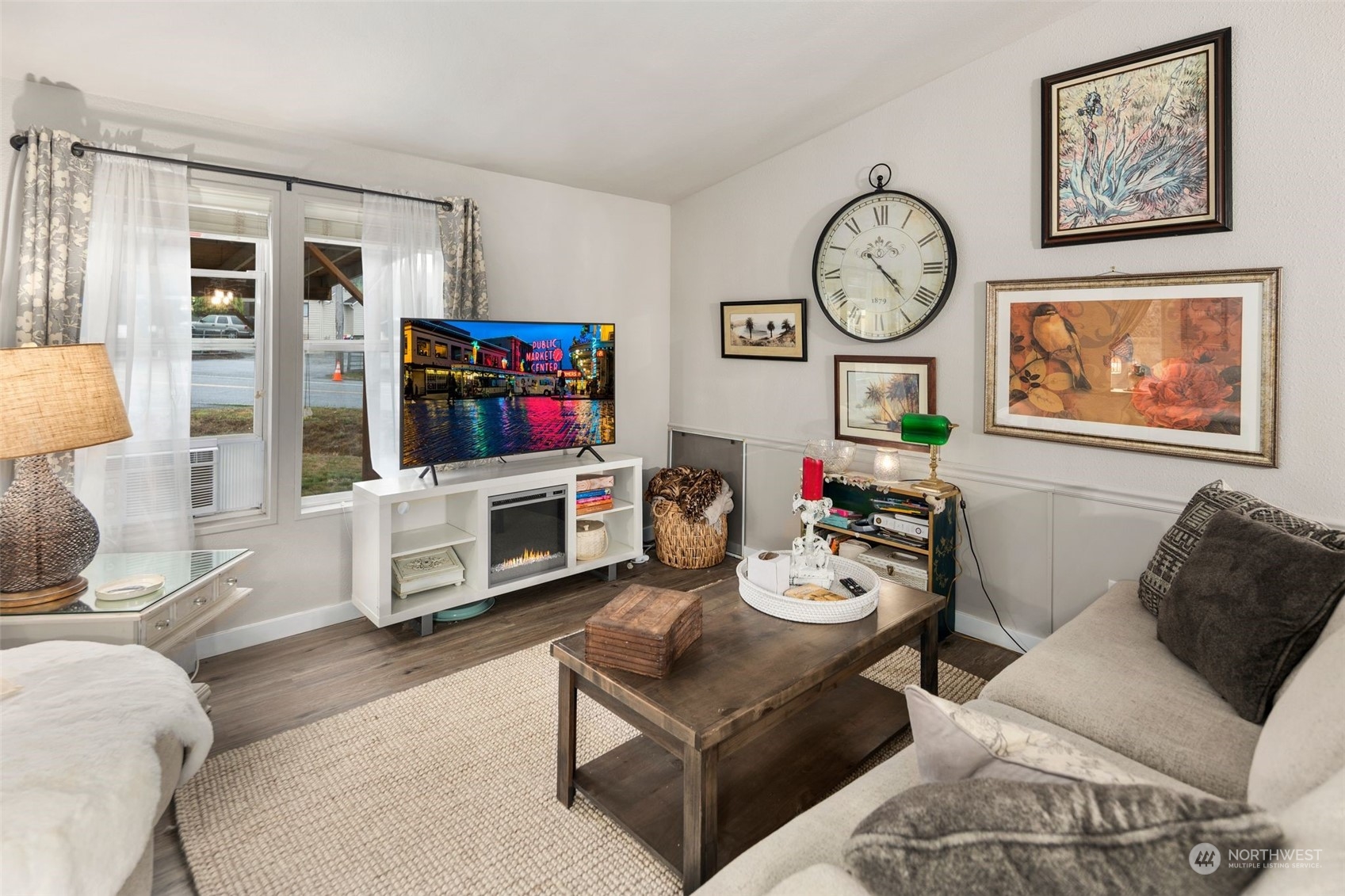 8730 206th Street Southeast, Unit 24 Snohomish, WA 98296 - Photo 6 of 33 a living room with furniture a clock on wall and a flat screen tv