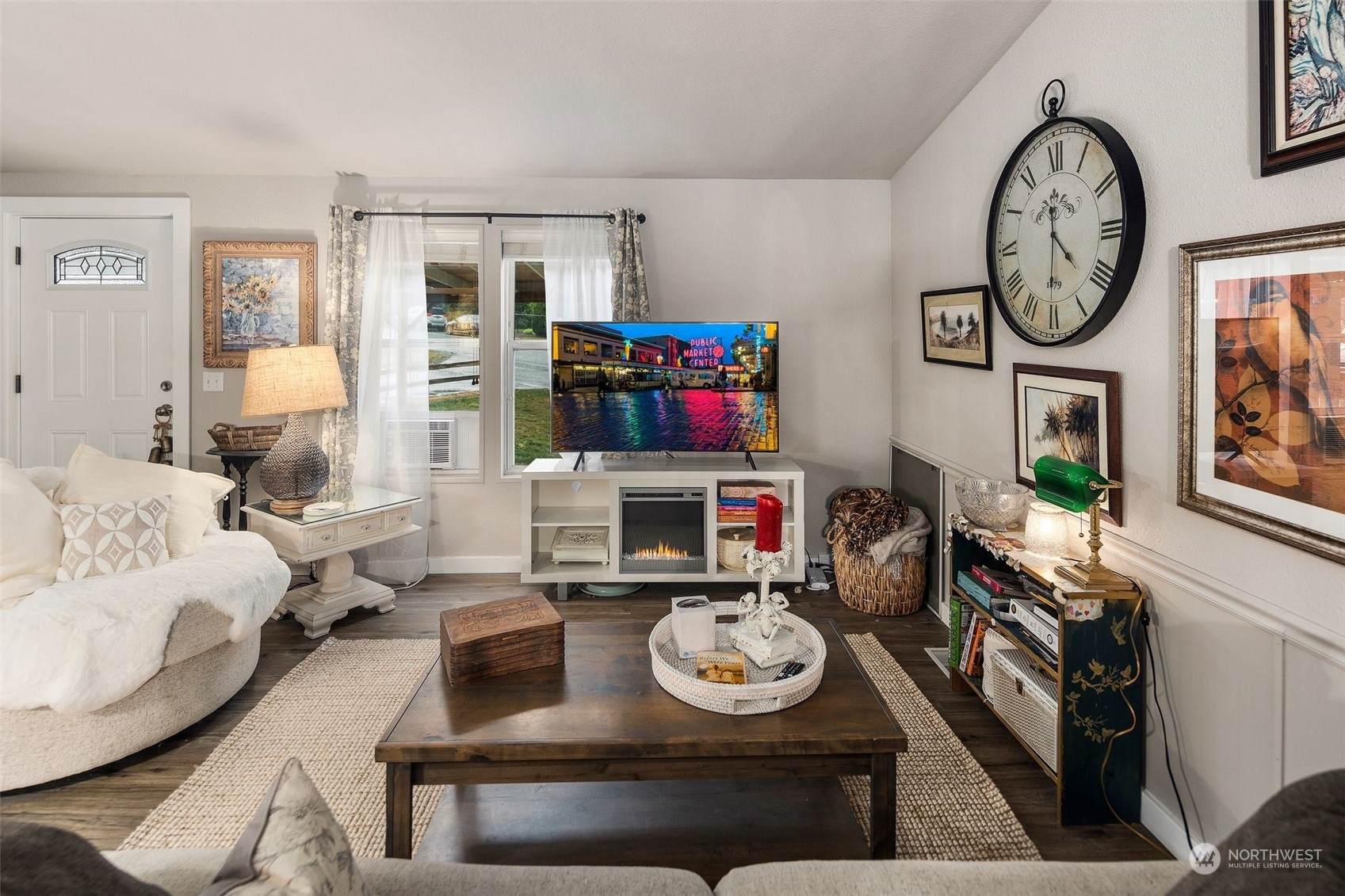8730 206th Street Southeast, Unit 24 Snohomish, WA 98296 - Photo 9 of 33 a living room with furniture a clock and a window