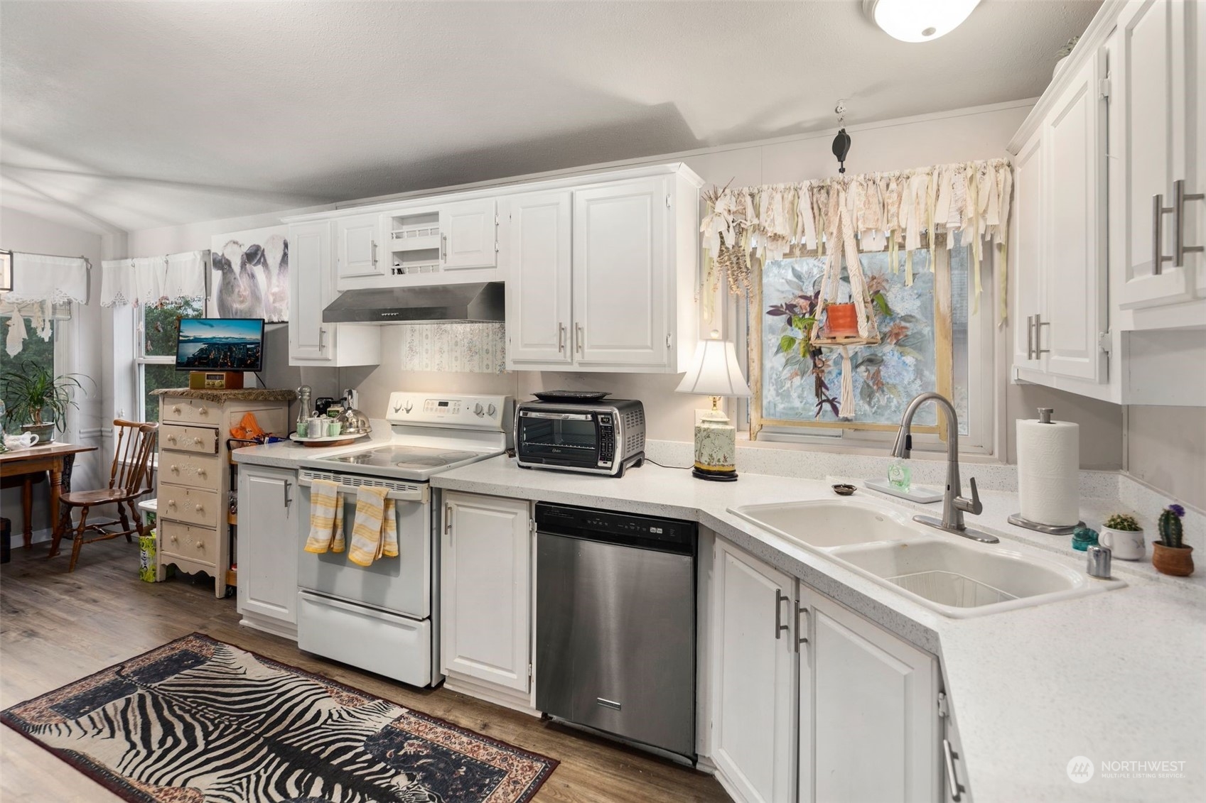 8730 206th Street Southeast, Unit 24 Snohomish, WA 98296 - Photo 10 of 33 a kitchen with a sink stove and cabinets