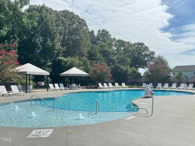 a view of a house with backyard and deck