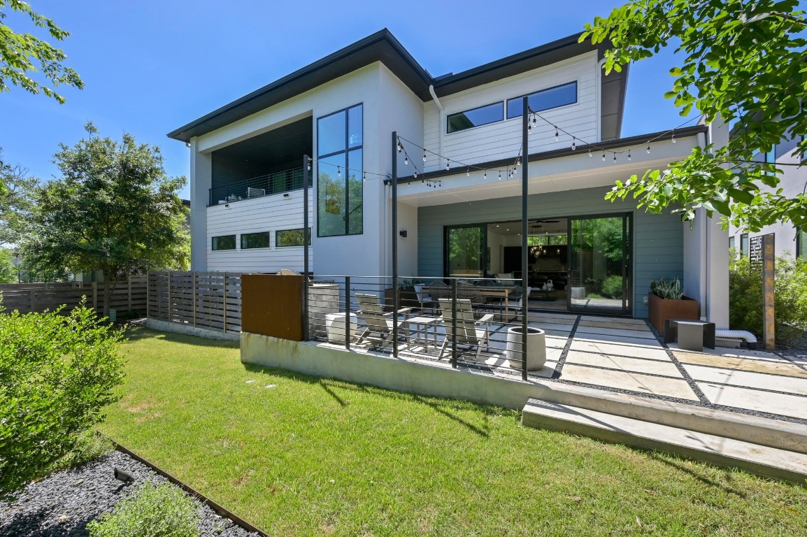 a swimming pool with outdoor seating and yard