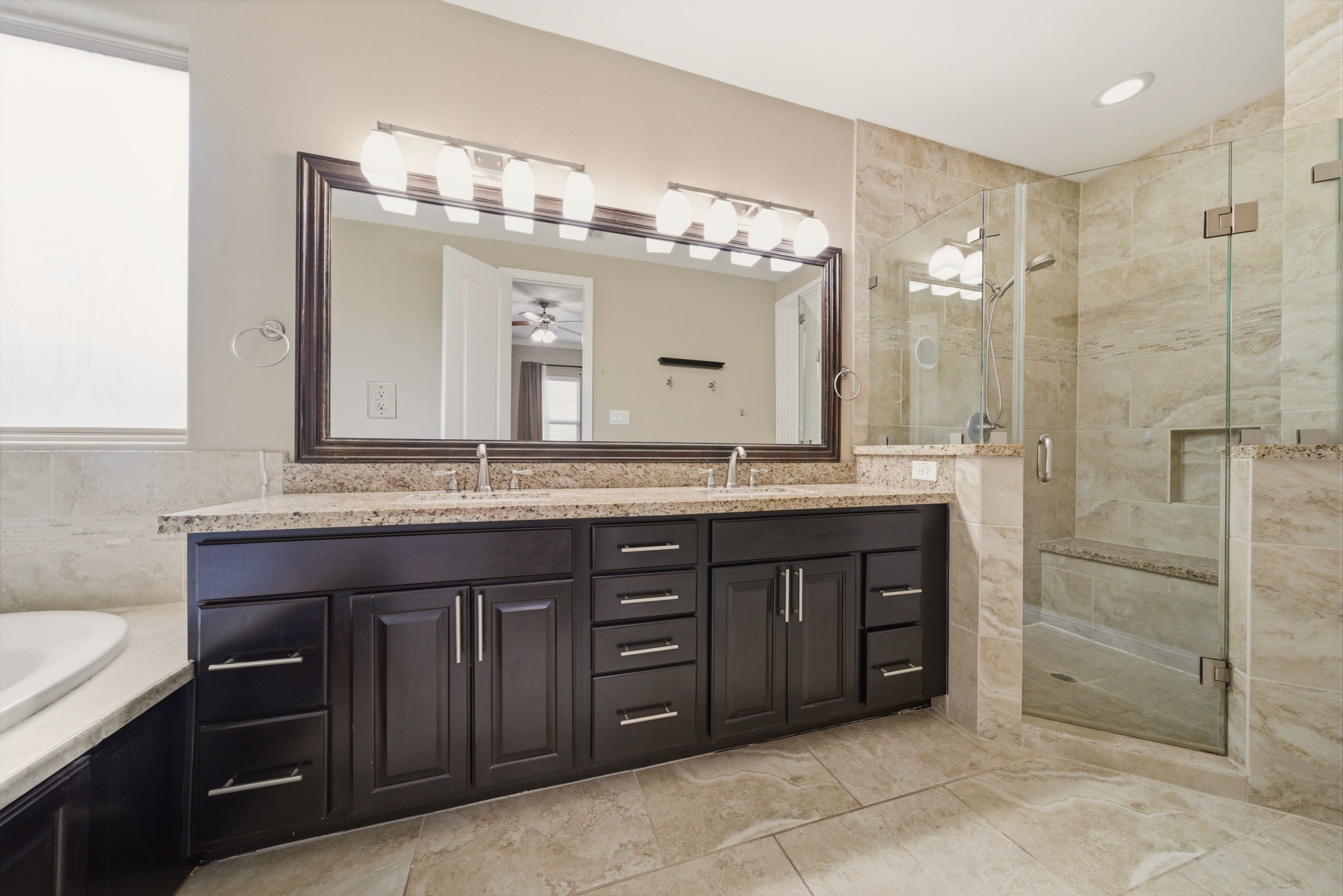 1113 West 18th Street, Unit A Houston, TX 77008 - Photo 13 of 21 a bathroom with a granite countertop sink a large mirror and a shower