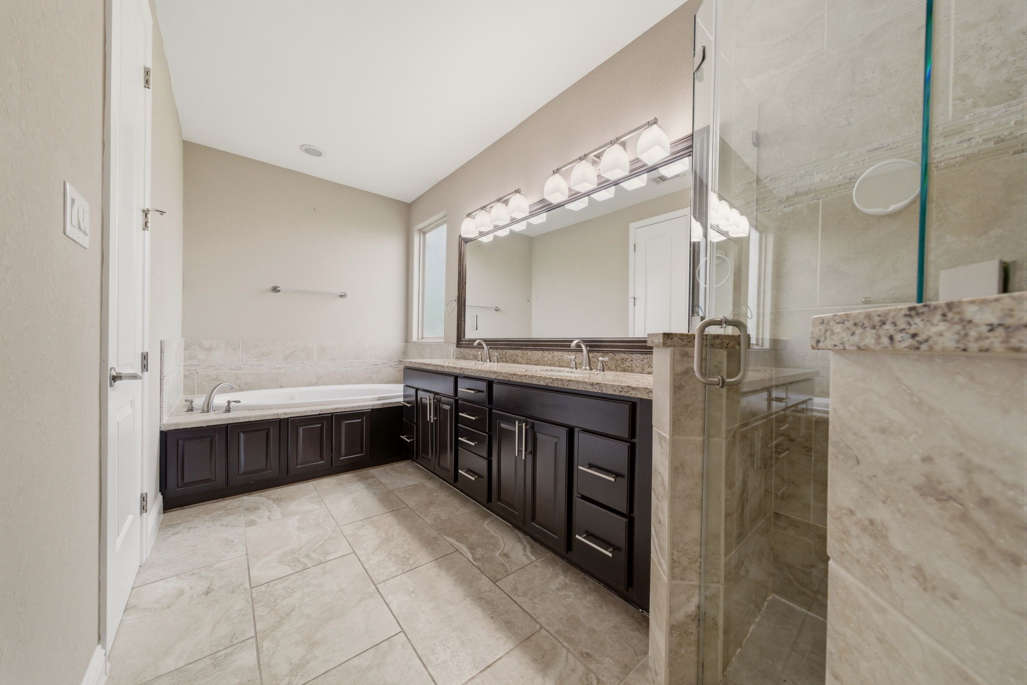 1113 West 18th Street, Unit A Houston, TX 77008 - Photo 14 of 21 a spacious bathroom with a granite countertop sink a mirror and a bathtub