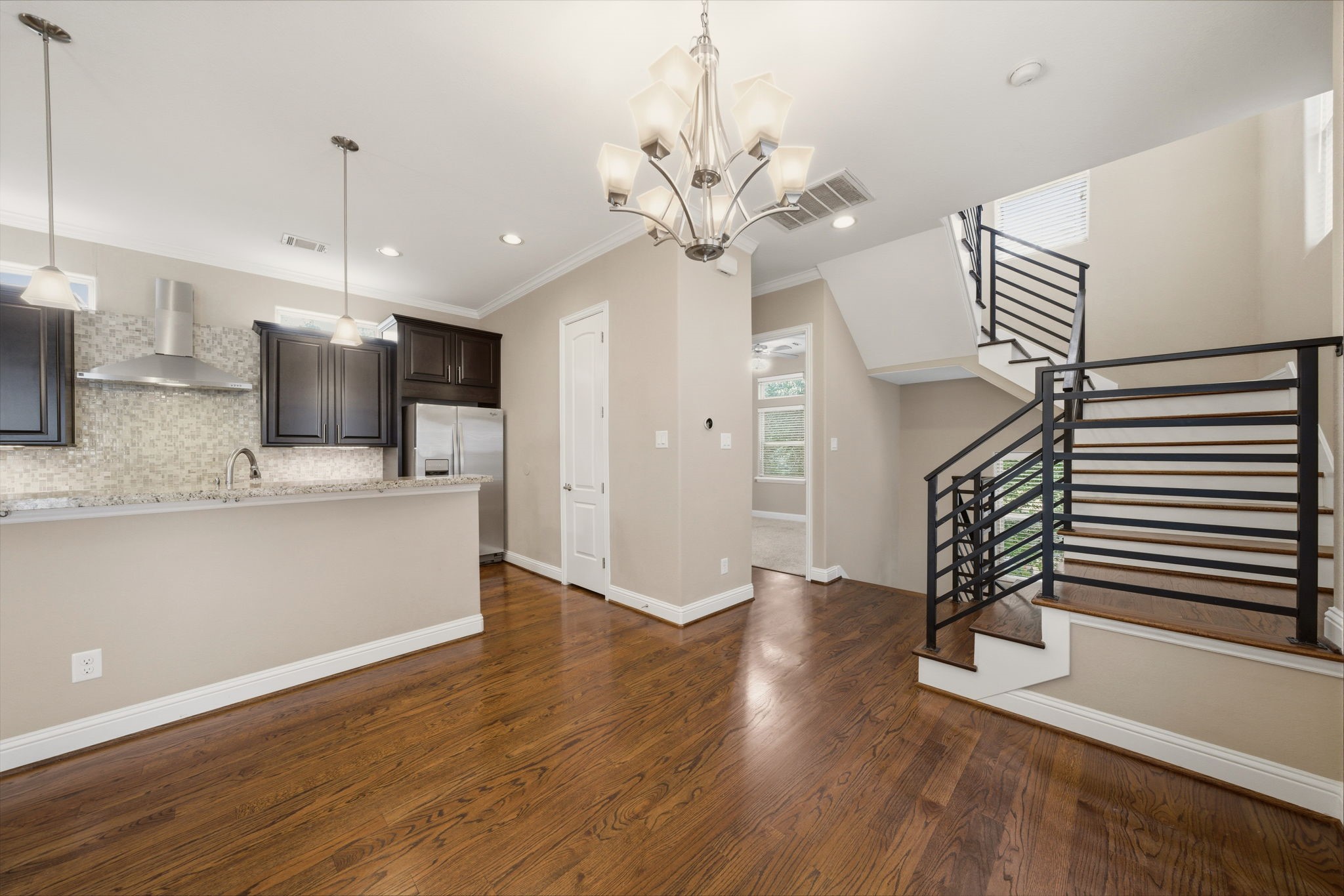 1113 West 18th Street, Unit A Houston, TX 77008 - Photo 4 of 21 a view of a kitchen with a sink wooden floor and a ceiling fan