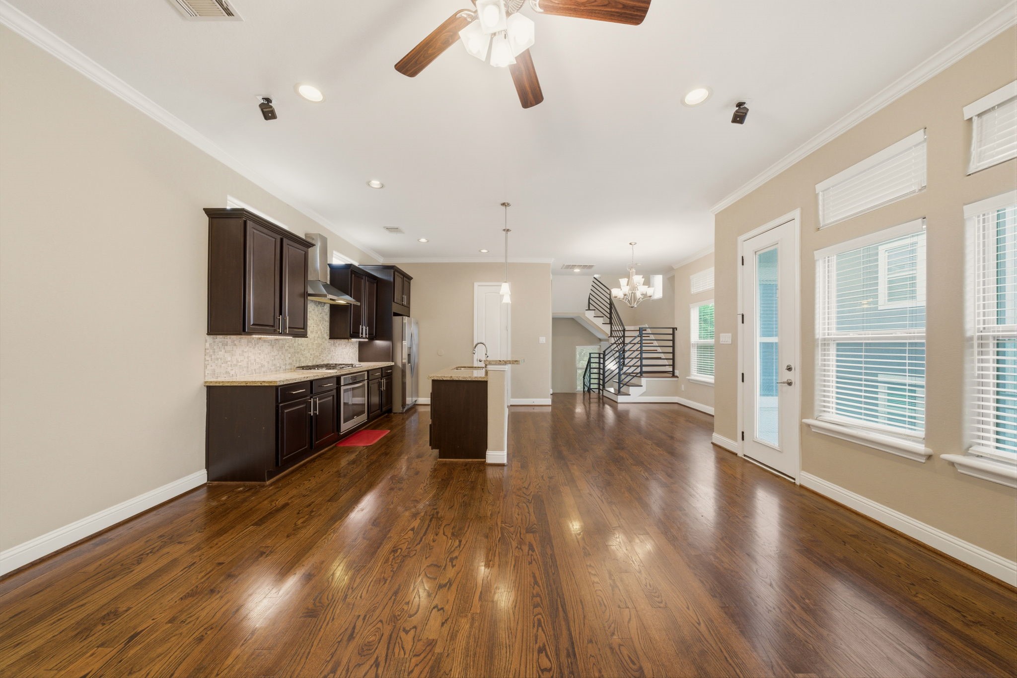 1113 West 18th Street, Unit A Houston, TX 77008 - Photo 6 of 21 a large kitchen with stainless steel appliances kitchen island a large counter top and a wooden floors