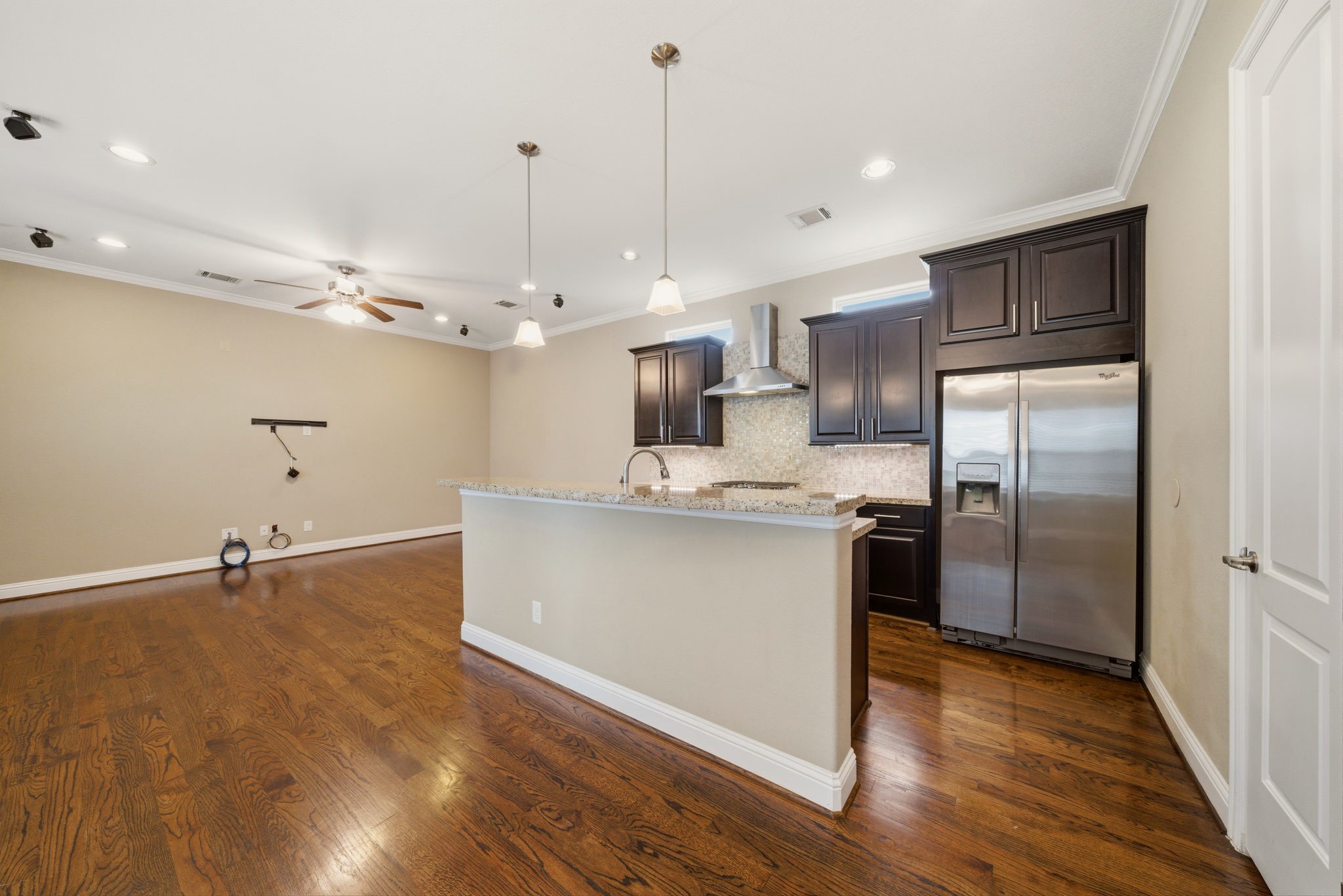 1113 West 18th Street, Unit A Houston, TX 77008 - Photo 7 of 21 a kitchen with kitchen island a counter top space a sink stainless steel appliances and cabinets