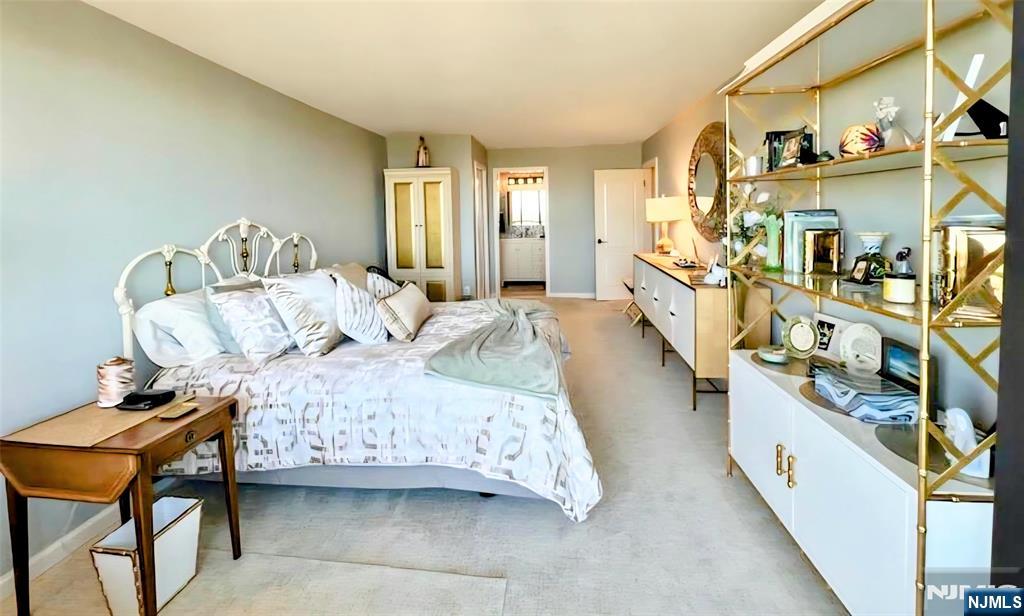 151 Prospect Avenue, Unit 16B Hackensack, NJ 07601 - Photo 13 of 25 a bedroom with a bed and a table in it