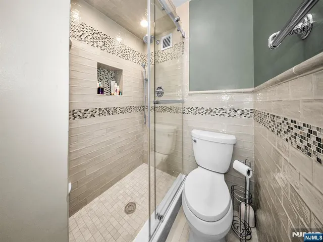 a bathroom with a toilet and a shower