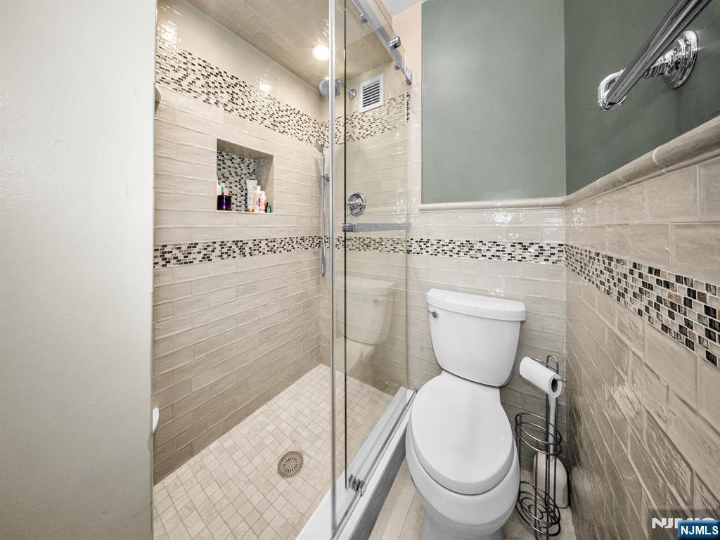 151 Prospect Avenue, Unit 16B Hackensack, NJ 07601 - Photo 15 of 25 a bathroom with a toilet and a shower
