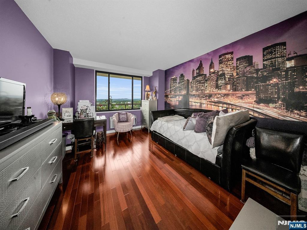 151 Prospect Avenue, Unit 16B Hackensack, NJ 07601 - Photo 16 of 25 a living room with furniture and wooden floor