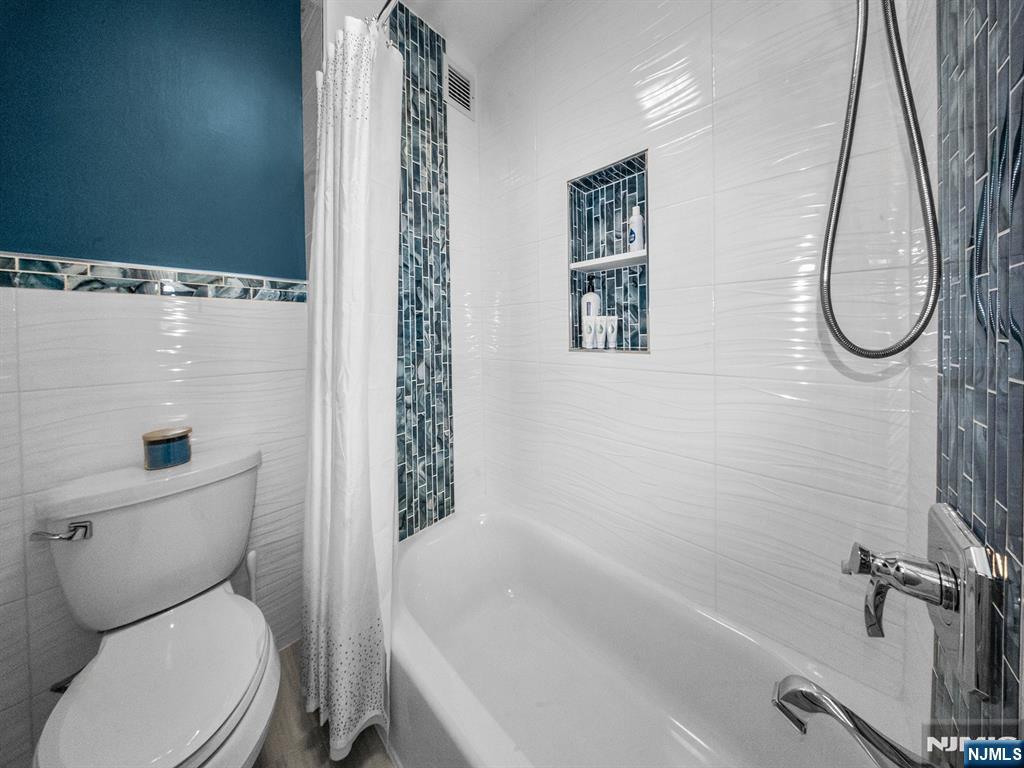 151 Prospect Avenue, Unit 16B Hackensack, NJ 07601 - Photo 18 of 25 a white toilet sitting next to a bath tub
