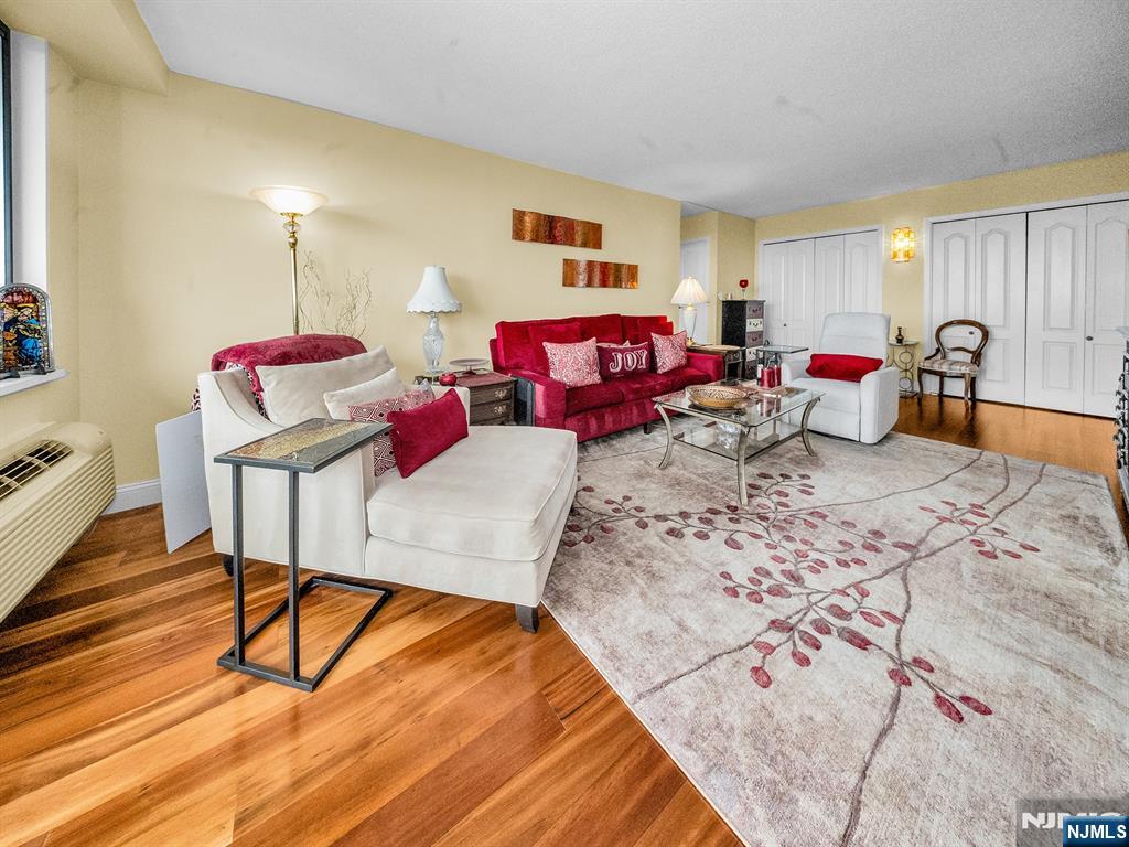 151 Prospect Avenue, Unit 16B Hackensack, NJ 07601 - Photo 3 of 25 a living room with furniture and a wooden floor