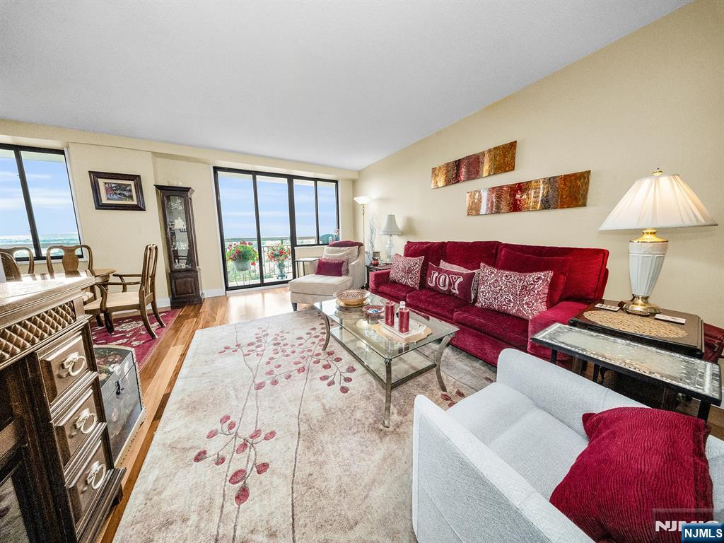151 Prospect Avenue, Unit 16B Hackensack, NJ 07601 - Photo 4 of 25 a living room with furniture and a large window