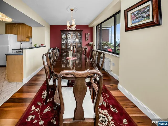 a view of a dining room with furniture and chandelier