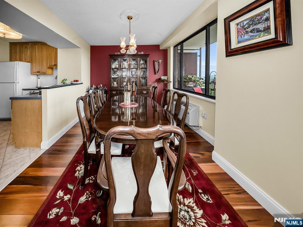 151 Prospect Avenue, Unit 16B Hackensack, NJ 07601 - Photo 6 of 25 a view of a dining room with furniture and chandelier