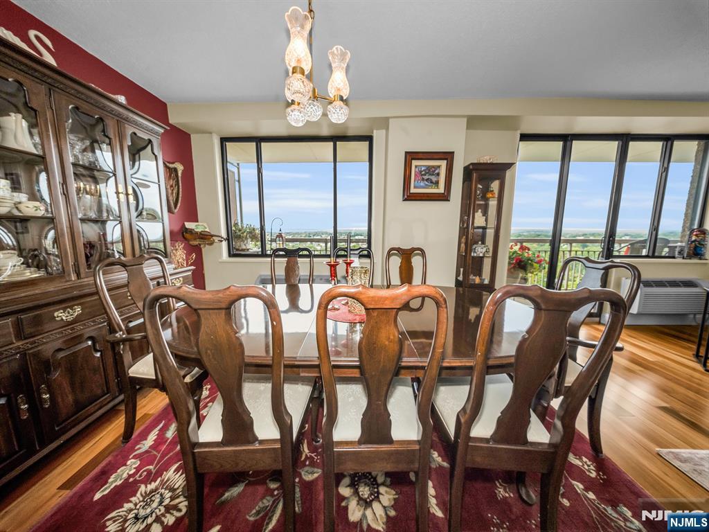 151 Prospect Avenue, Unit 16B Hackensack, NJ 07601 - Photo 7 of 25 a dining room with furniture a flat screen tv and a large window