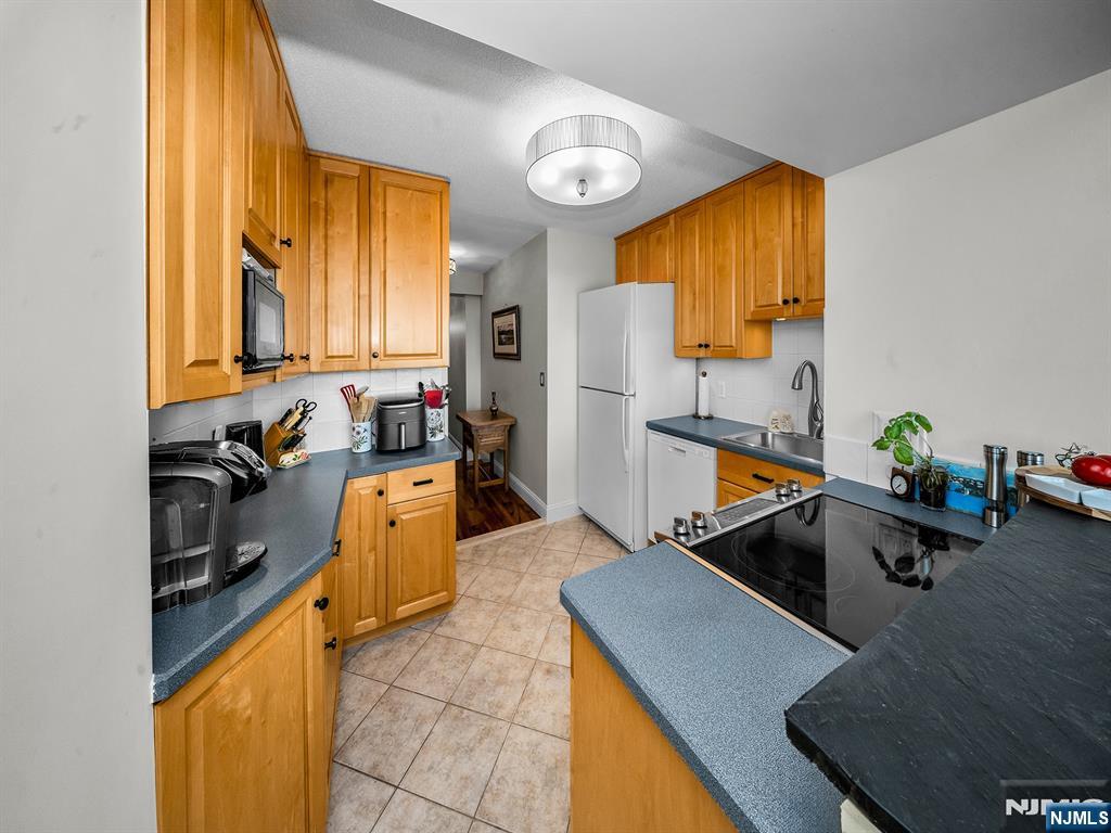 151 Prospect Avenue, Unit 16B Hackensack, NJ 07601 - Photo 10 of 25 a view of a kitchen with a sink and cabinets