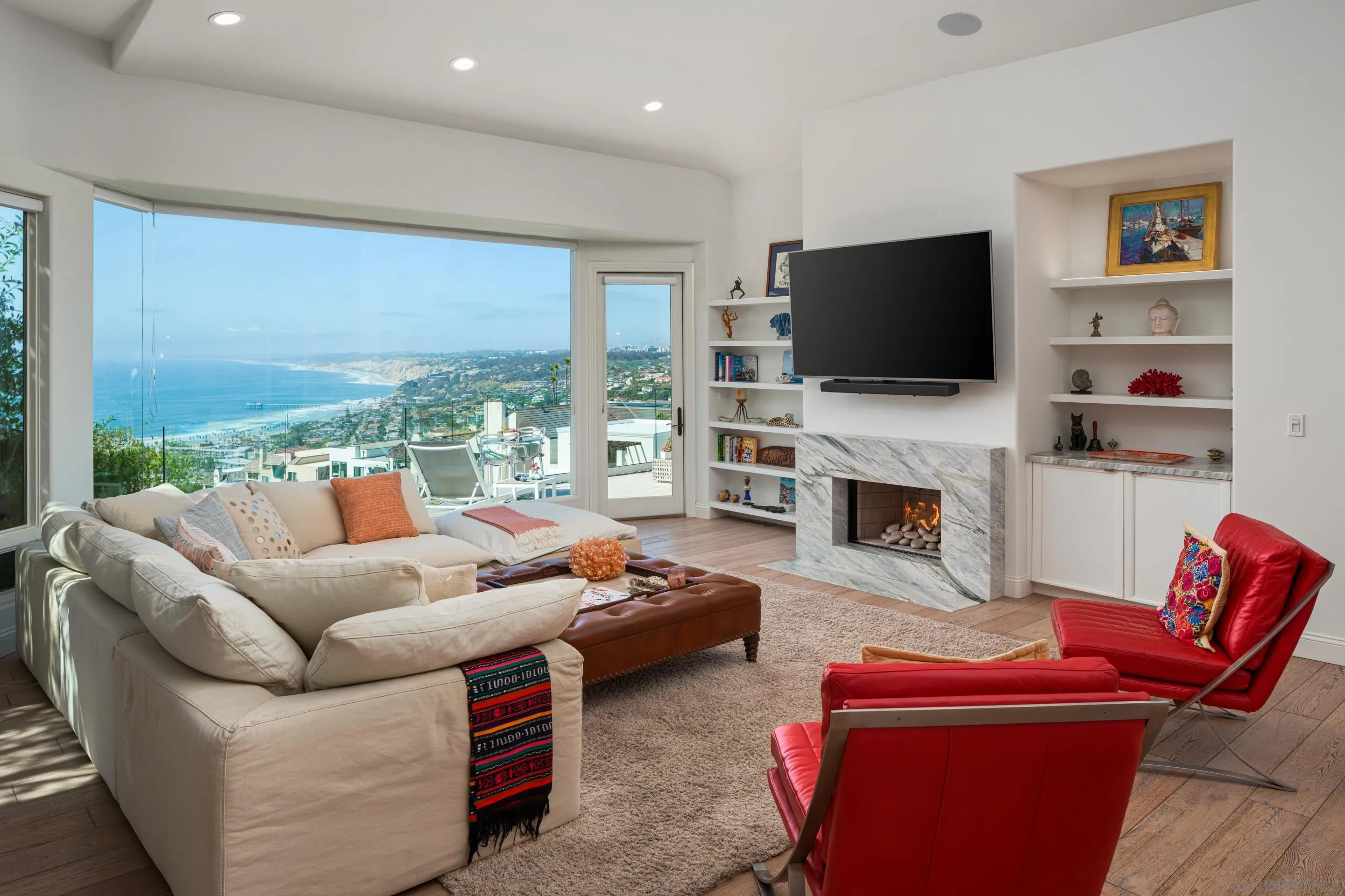 7403 Hillside Drive La Jolla, CA 92037 - Photo 28 of 52 a living room with furniture a flat screen tv and a fireplace