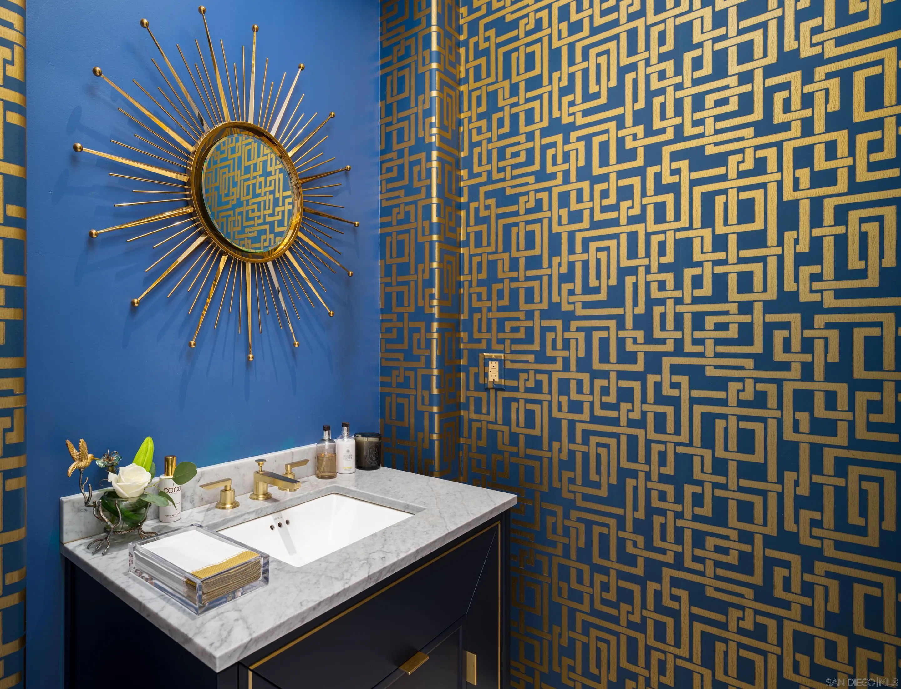 7403 Hillside Drive La Jolla, CA 92037 - Photo 36 of 52 a bathroom with a sink a mirror and a toilet