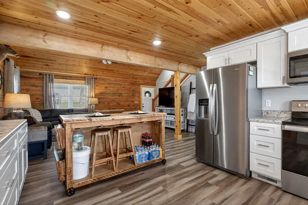 a kitchen with a stove a refrigerator and wooden cabinets