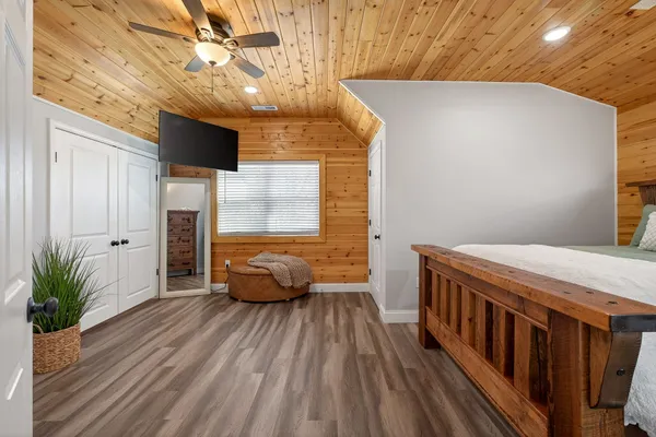 a bedroom with bed and wooden floor