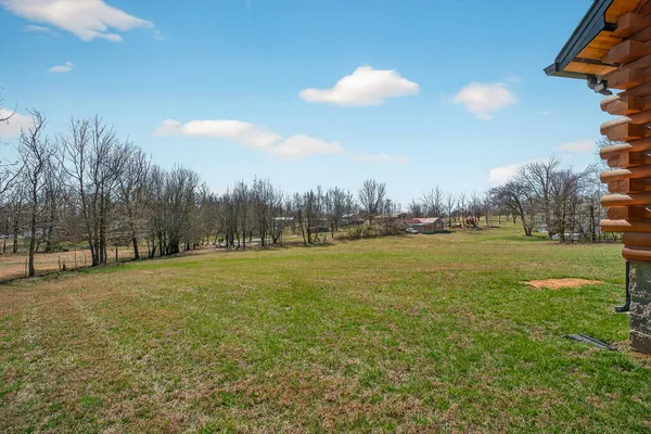 a view of a field with trees