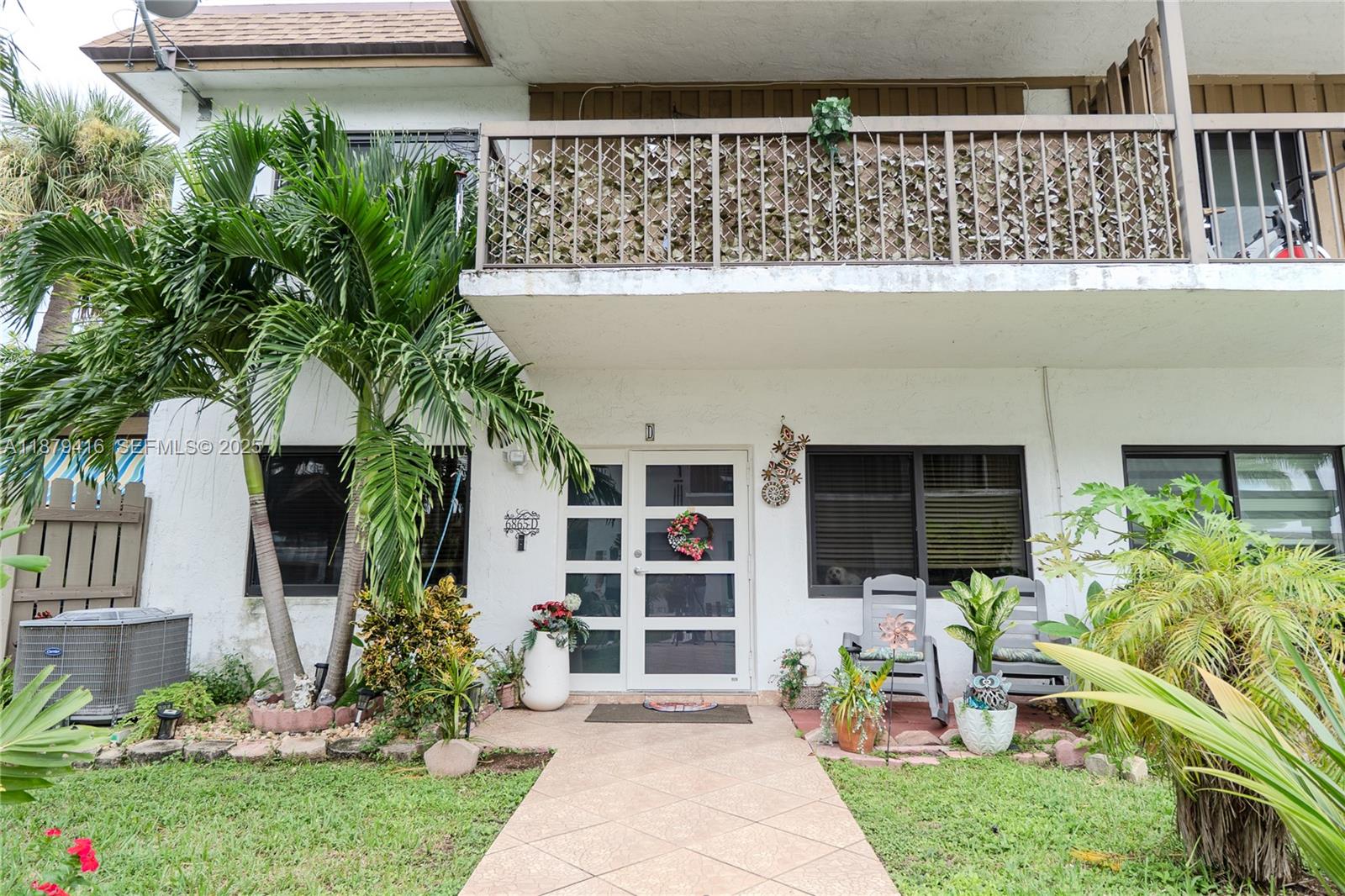 6865 Northwest 169th Street, Unit D Hialeah, FL 33015 - Photo 1 of 21 front view of house with a yard and potted plants