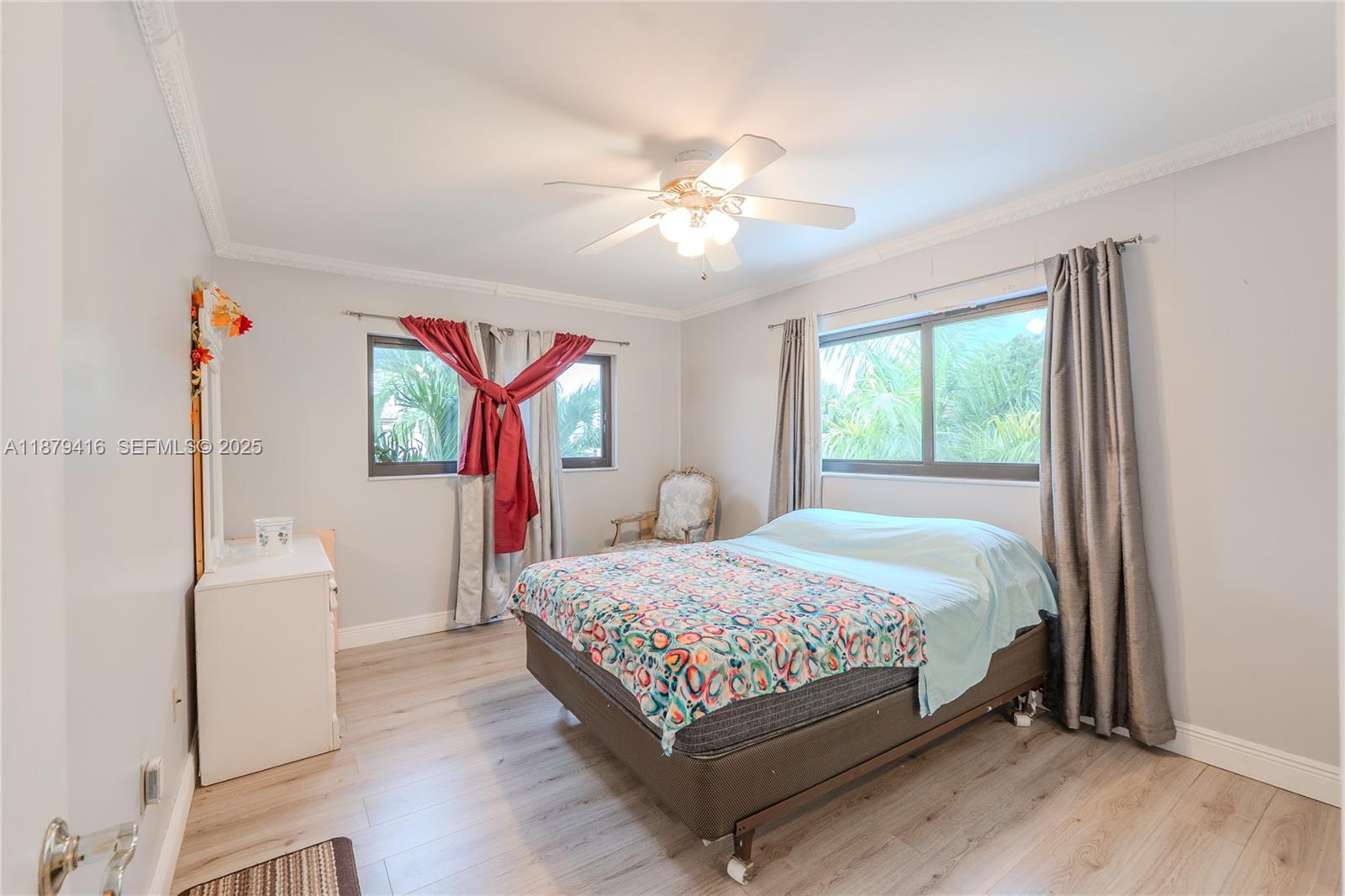 6865 Northwest 169th Street, Unit D Hialeah, FL 33015 - Photo 12 of 21 a bedroom with a bed and a chandelier
