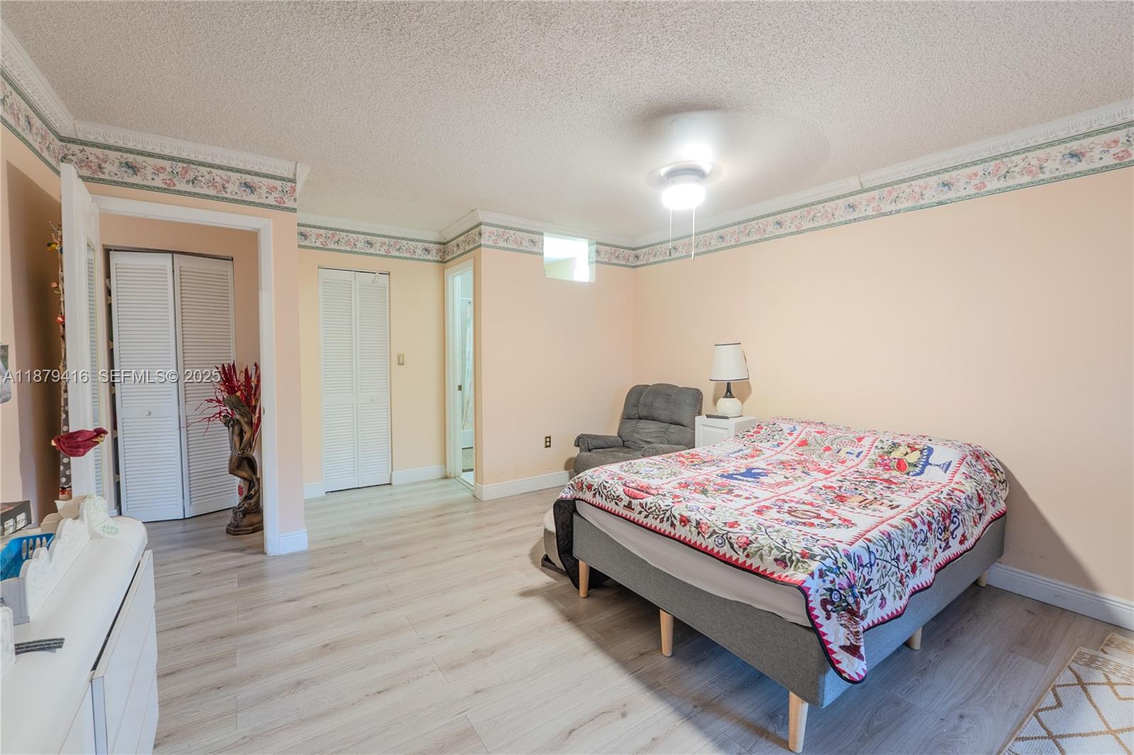 6865 Northwest 169th Street, Unit D Hialeah, FL 33015 - Photo 17 of 21 a bedroom with a bed and a mirror