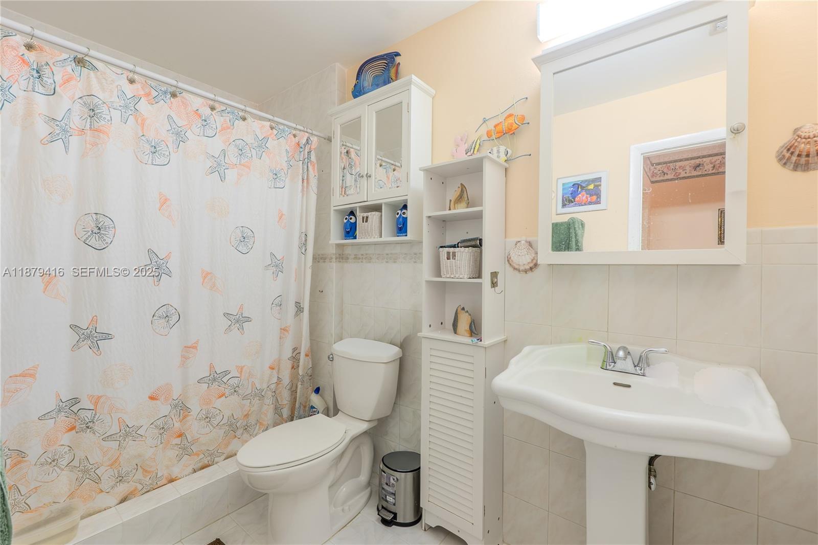 6865 Northwest 169th Street, Unit D Hialeah, FL 33015 - Photo 18 of 21 a bathroom with a sink toilet and shower