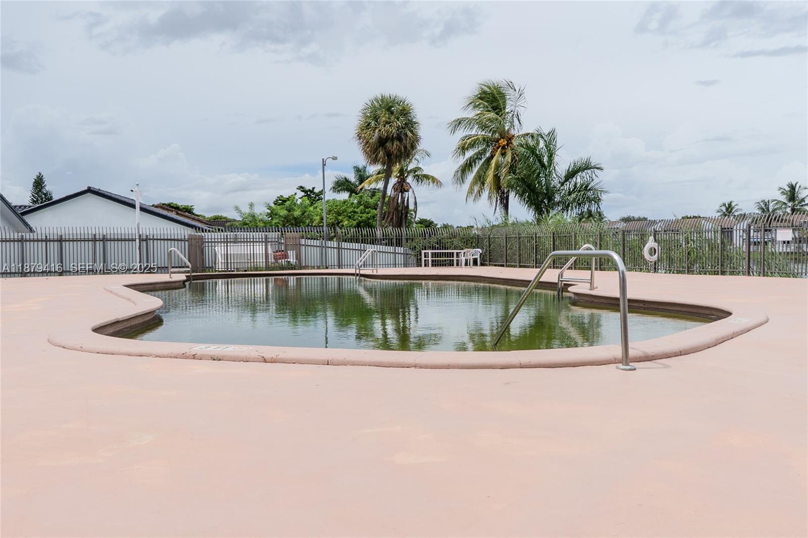 6865 Northwest 169th Street, Unit D Hialeah, FL 33015 - Photo 19 of 21 a view of a house with a yard and potted plants