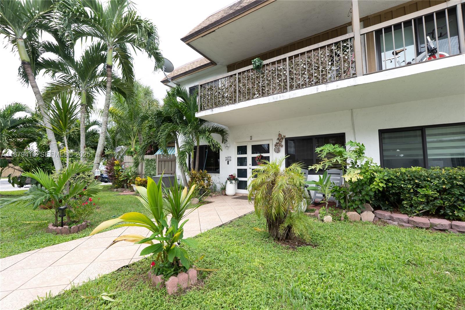 6865 Northwest 169th Street, Unit D Hialeah, FL 33015 - Photo 2 of 21 a view of house with backyard and sitting area