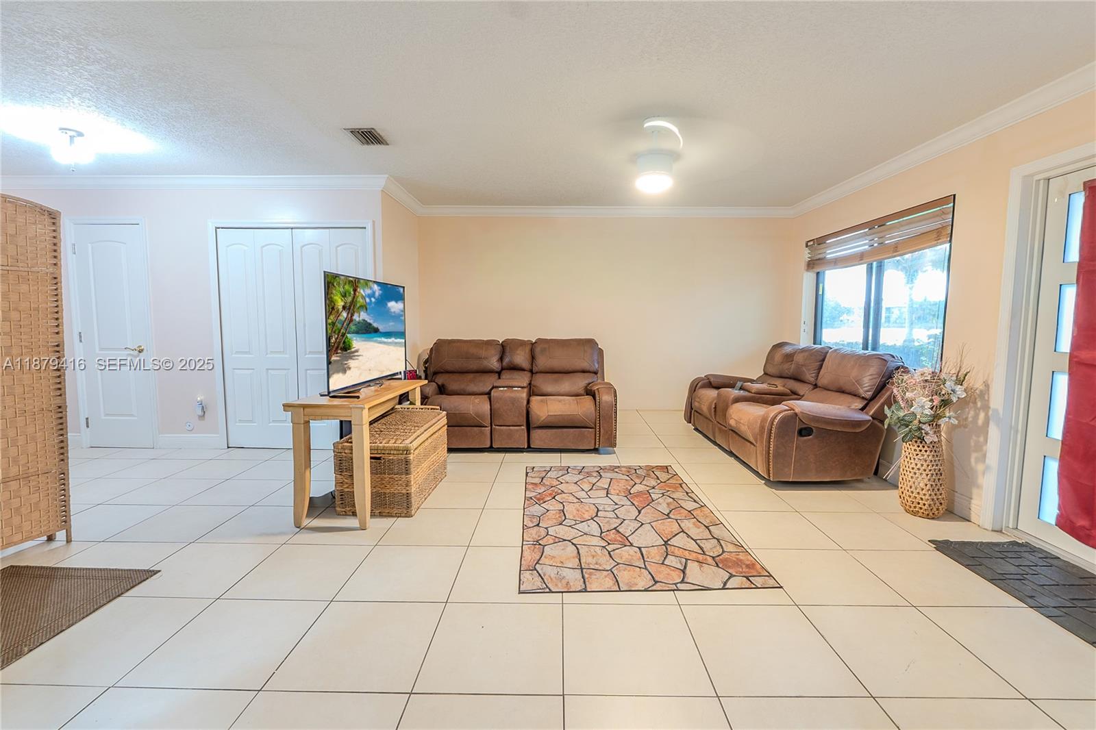 6865 Northwest 169th Street, Unit D Hialeah, FL 33015 - Photo 3 of 21 a living room with furniture and a rug