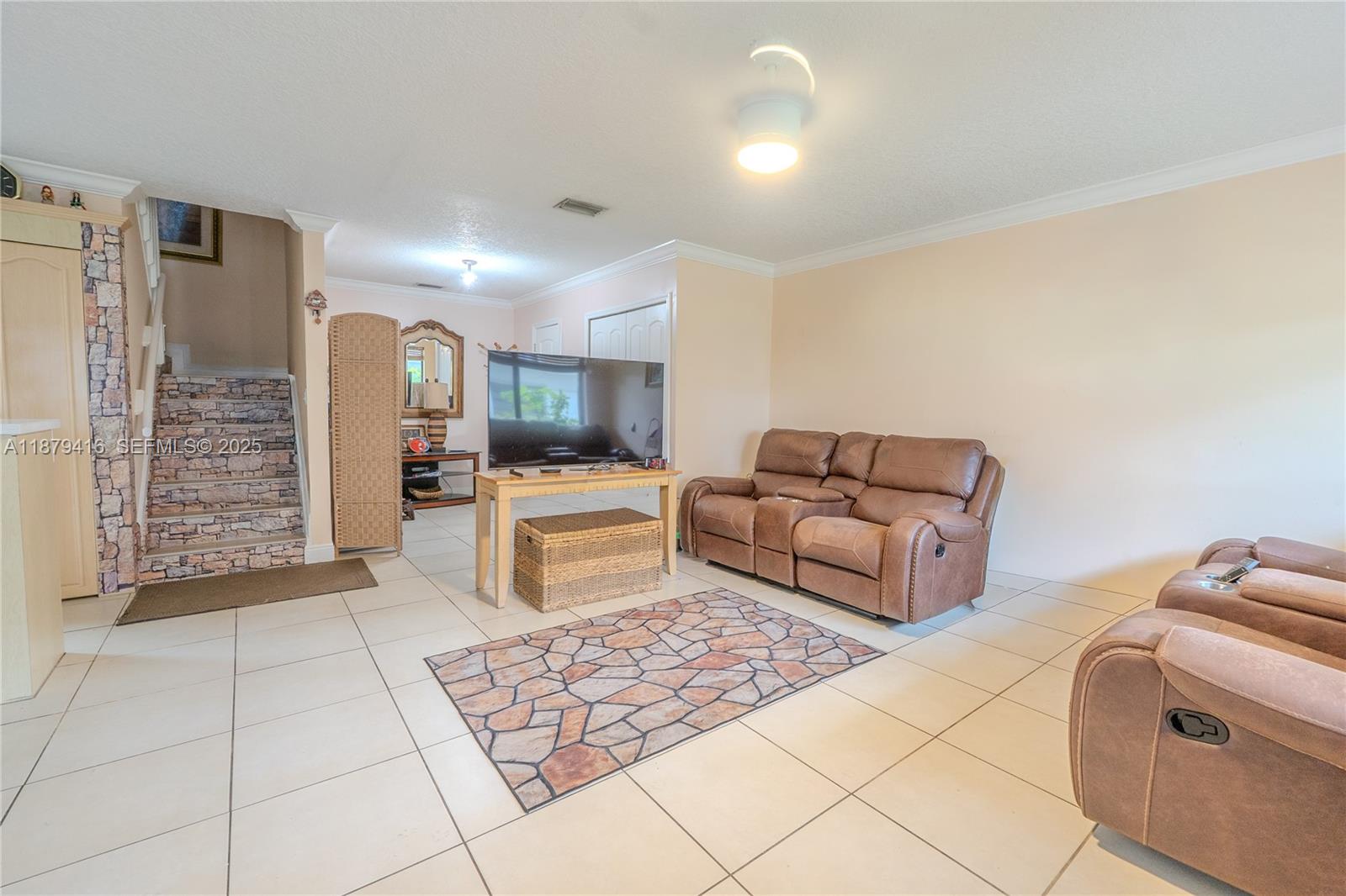 6865 Northwest 169th Street, Unit D Hialeah, FL 33015 - Photo 4 of 21 a living room with furniture and a couch