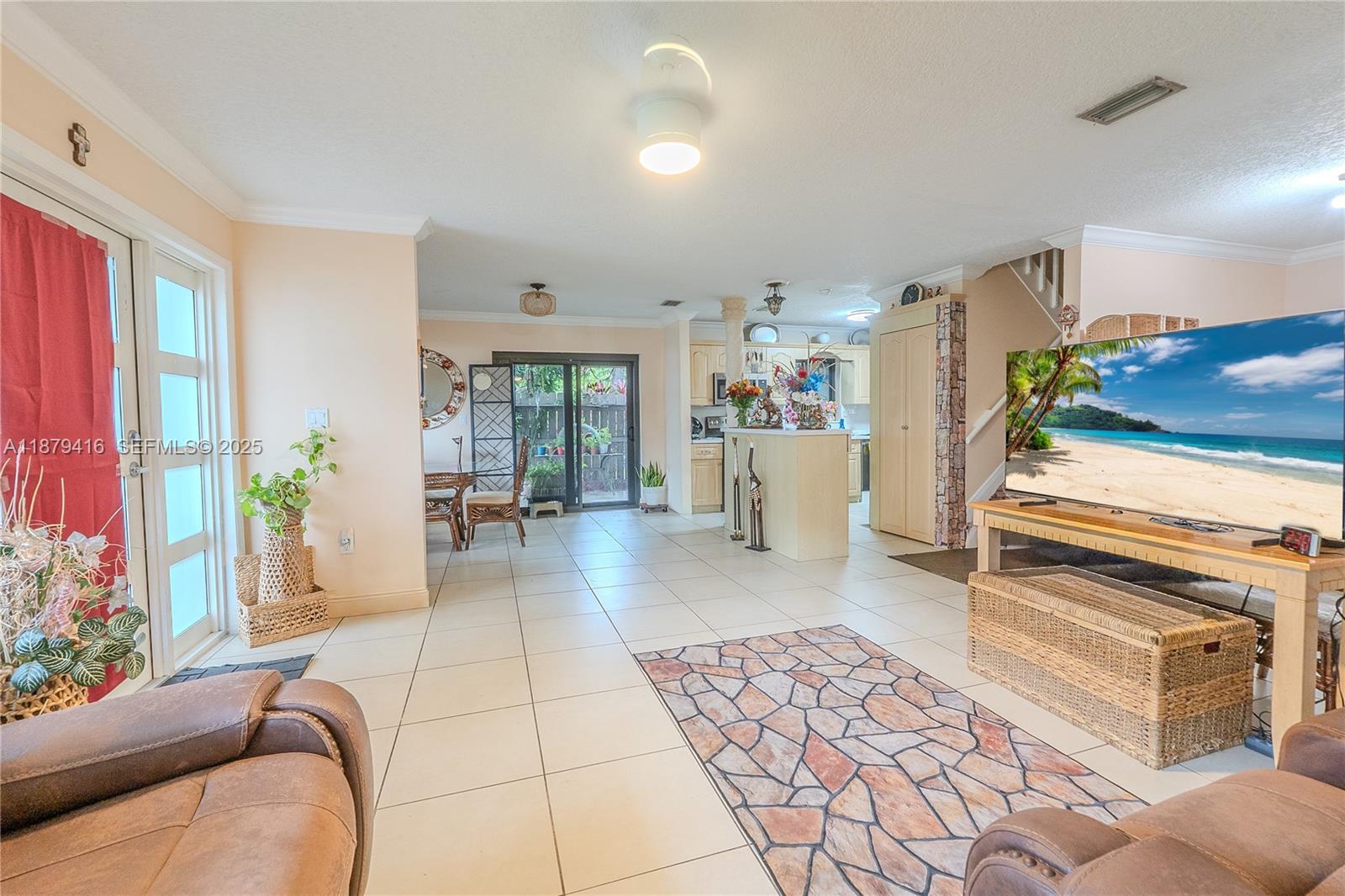6865 Northwest 169th Street, Unit D Hialeah, FL 33015 - Photo 5 of 21 a living room with furniture and a table