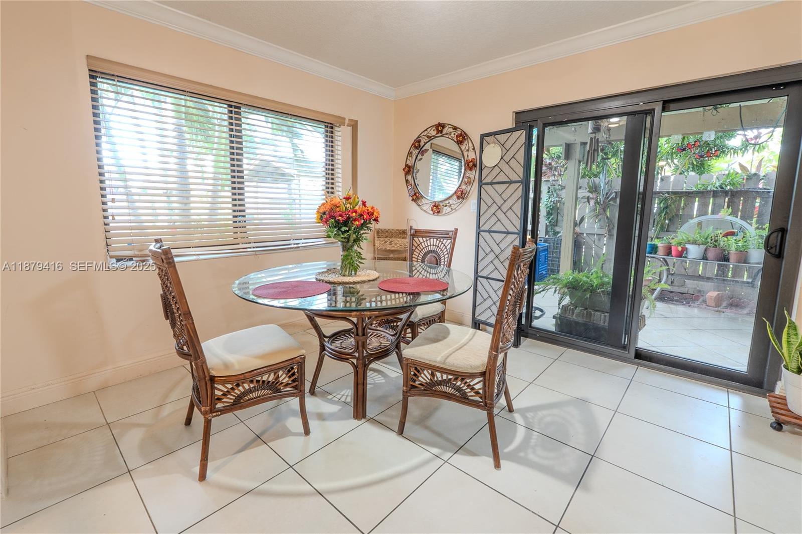 6865 Northwest 169th Street, Unit D Hialeah, FL 33015 - Photo 6 of 21 a view of a dining room with furniture a livingroom and chandelier