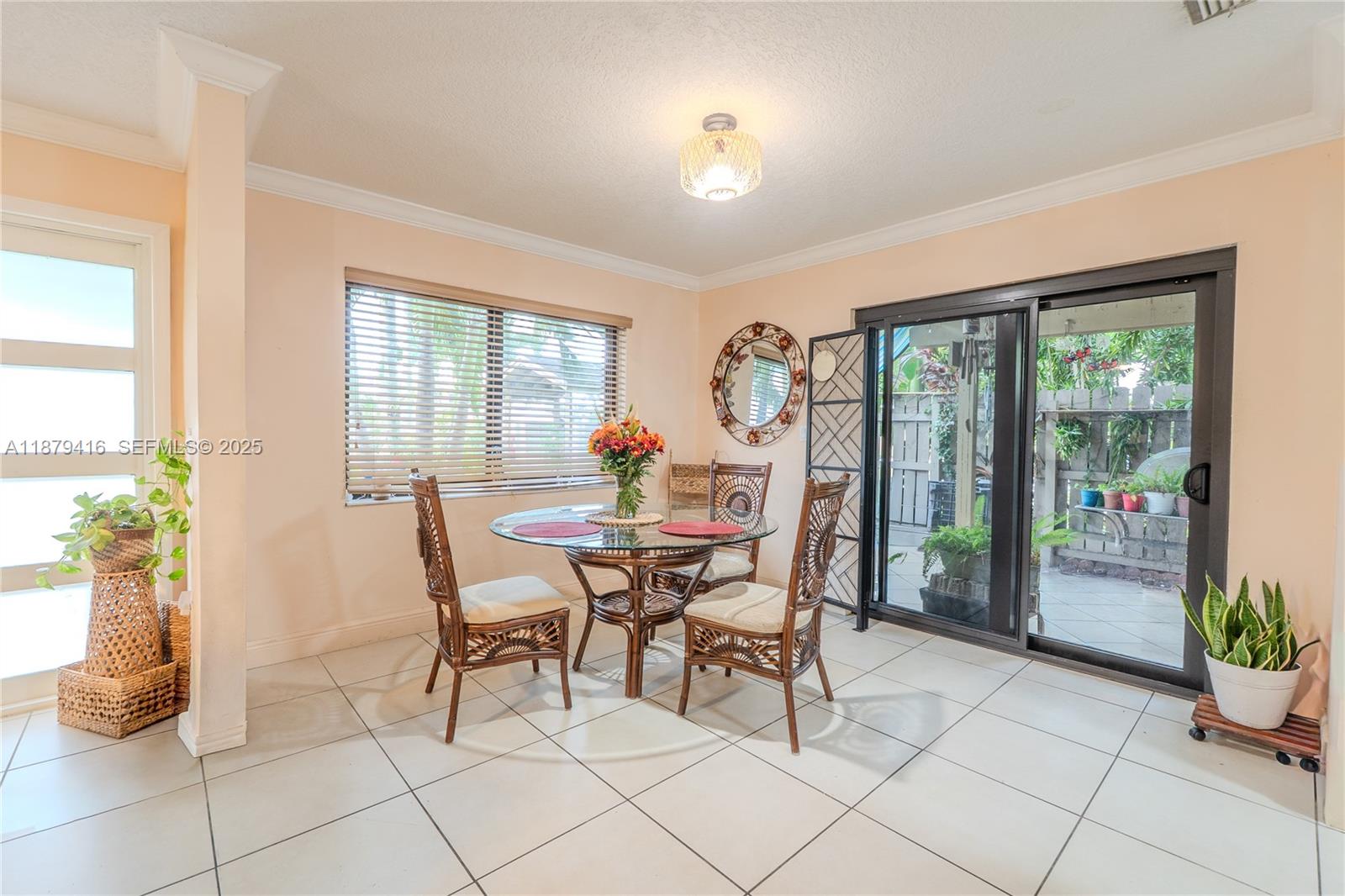 6865 Northwest 169th Street, Unit D Hialeah, FL 33015 - Photo 7 of 21 a dining room with furniture and wooden floor