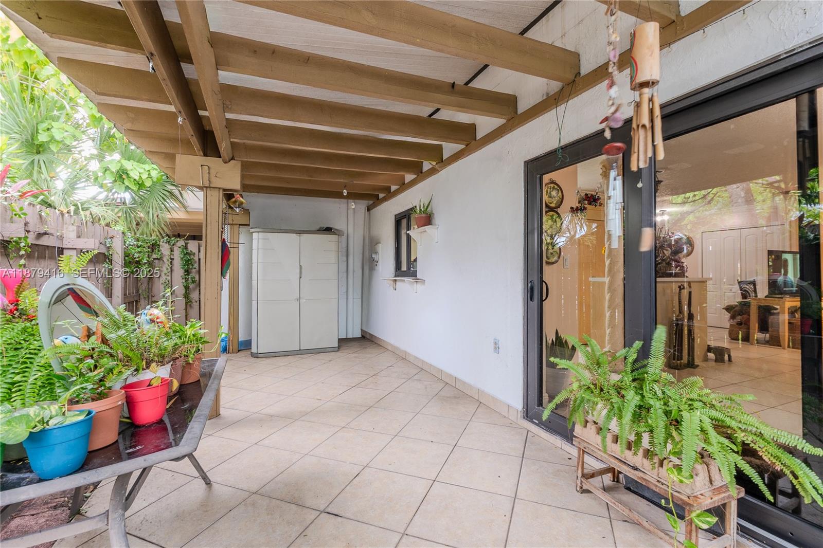 6865 Northwest 169th Street, Unit D Hialeah, FL 33015 - Photo 10 of 21 a view of an entryway with flower pots