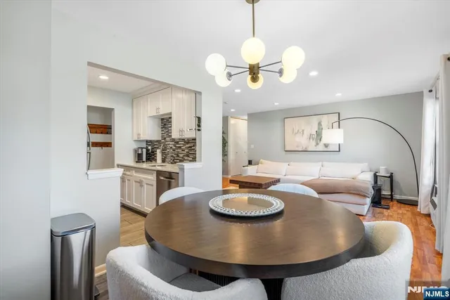 a kitchen with granite countertop a sink stove and refrigerator