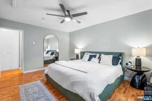 a bedroom with a bed and a chandelier