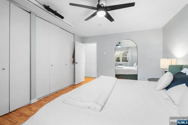 a bedroom with a large bed and a window