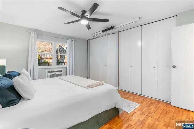 a bedroom with a bed and a large window