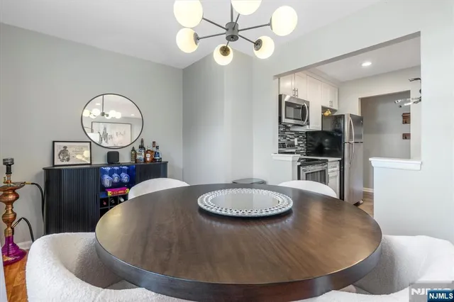 a living room with dining table and chairs