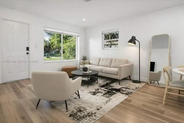 a living room with furniture rug and window
