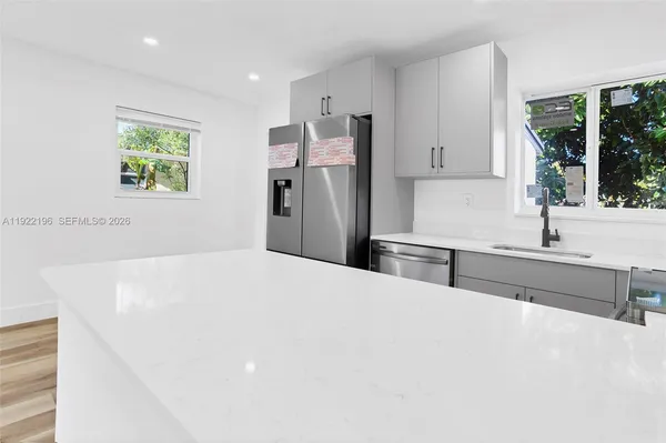 a kitchen with stainless steel appliances a refrigerator and a sink