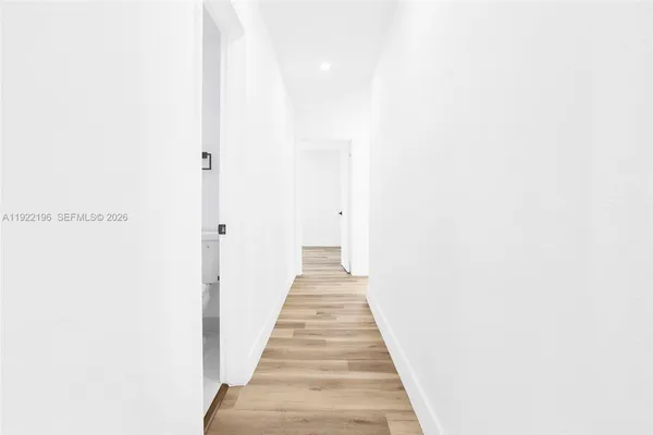 a view of a hallway with wooden floor
