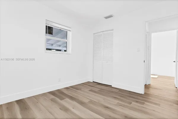 a view of a room with wooden floor