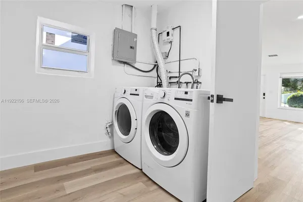 a view of a hallway with washer and dryer