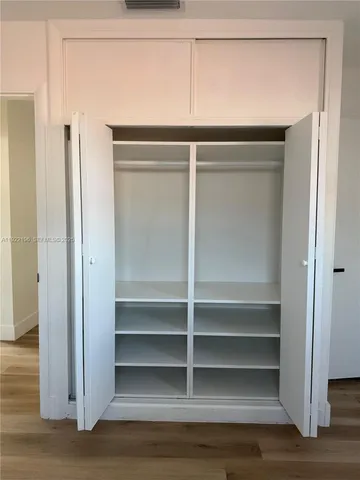 a kitchen with a refrigerator a stove top oven a sink and dishwasher with wooden floor