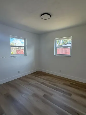 a view of bedroom and bedroom with wooden floor